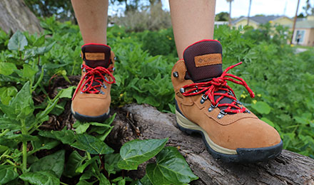 Hiker standing on a rock in hiking boots